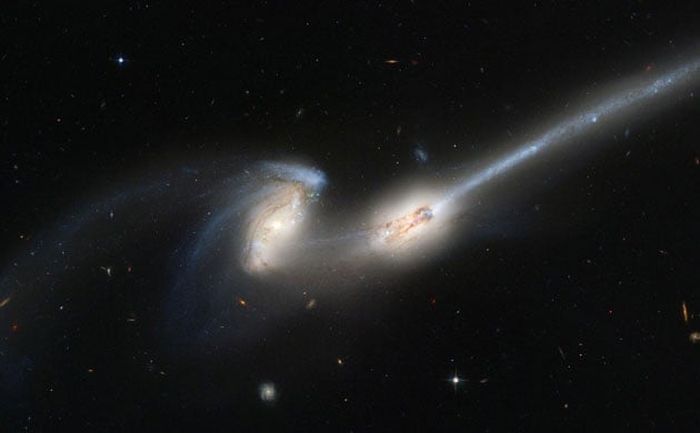 A pair of galaxies engaged in a celestial dance of cat and mouse